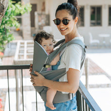 Load image into Gallery viewer, A mom with sun glasses wears the Cococho Ergonomic Baby Carrier in the front position