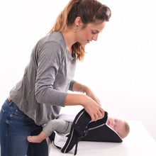 Load image into Gallery viewer, A mom holds the Cococho baby carrier with her baby after she fell asleep in the carrier and she off loaded her