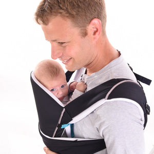 A father smiling with his baby in the Cococho Ergonomic baby carrier in the front position